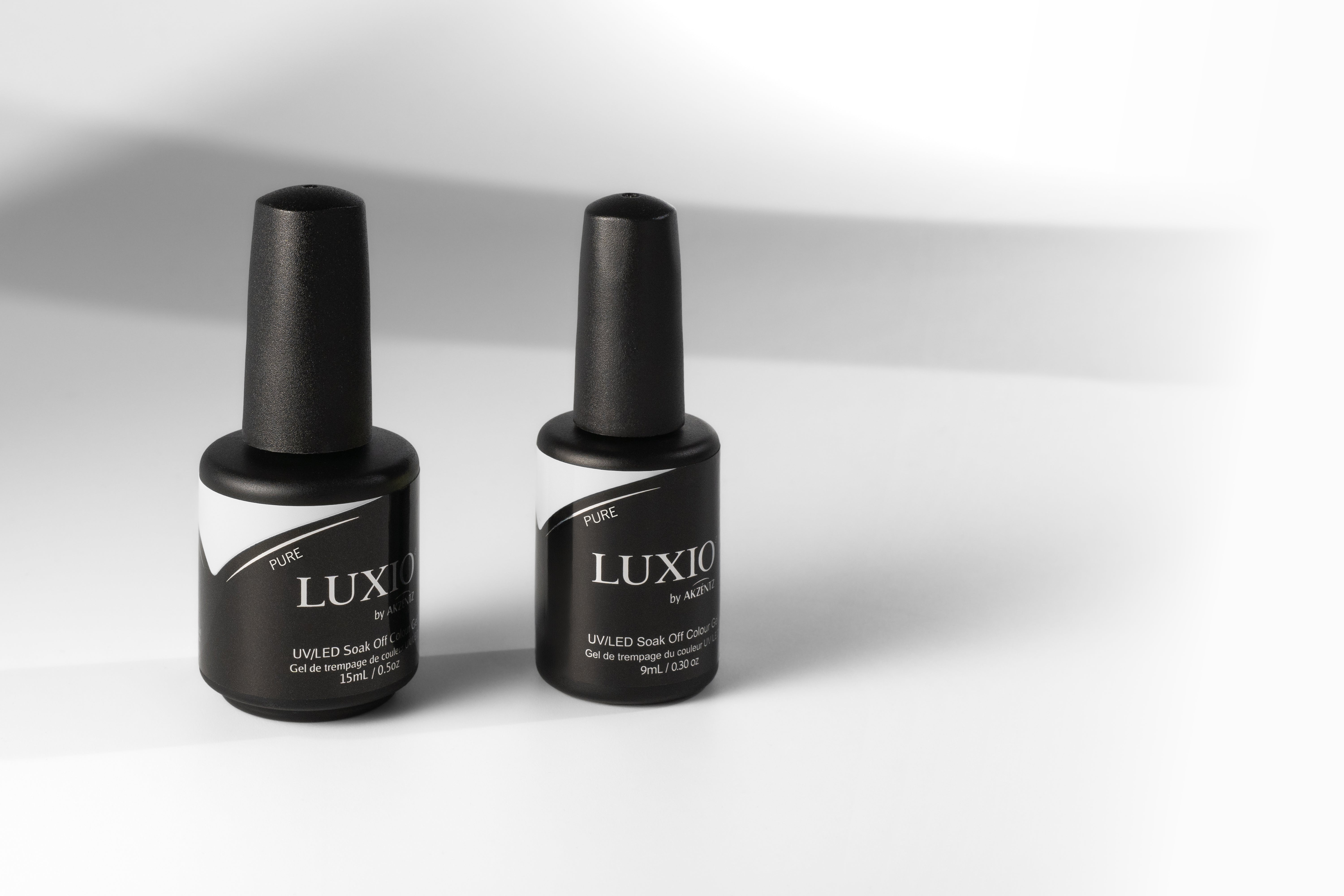 Two black nail polish bottles with 'LUX' branding on a white background